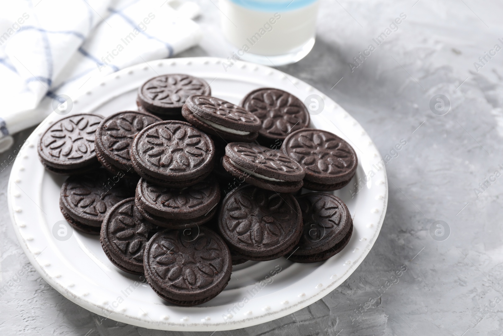 Photo of Many tasty sandwich cookies on light grey table. Space for text