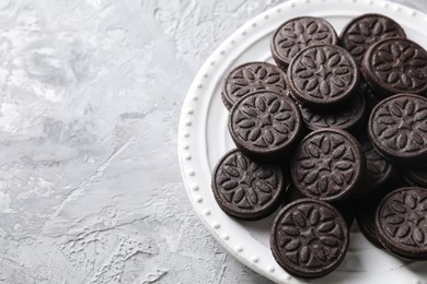 Photo of Many tasty sandwich cookies on light grey table, top view. Space for text