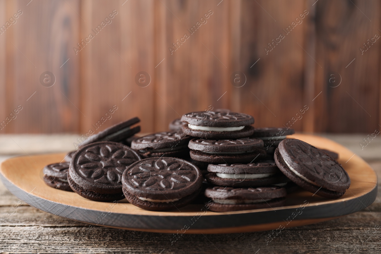 Photo of Many tasty sandwich cookies on wooden table