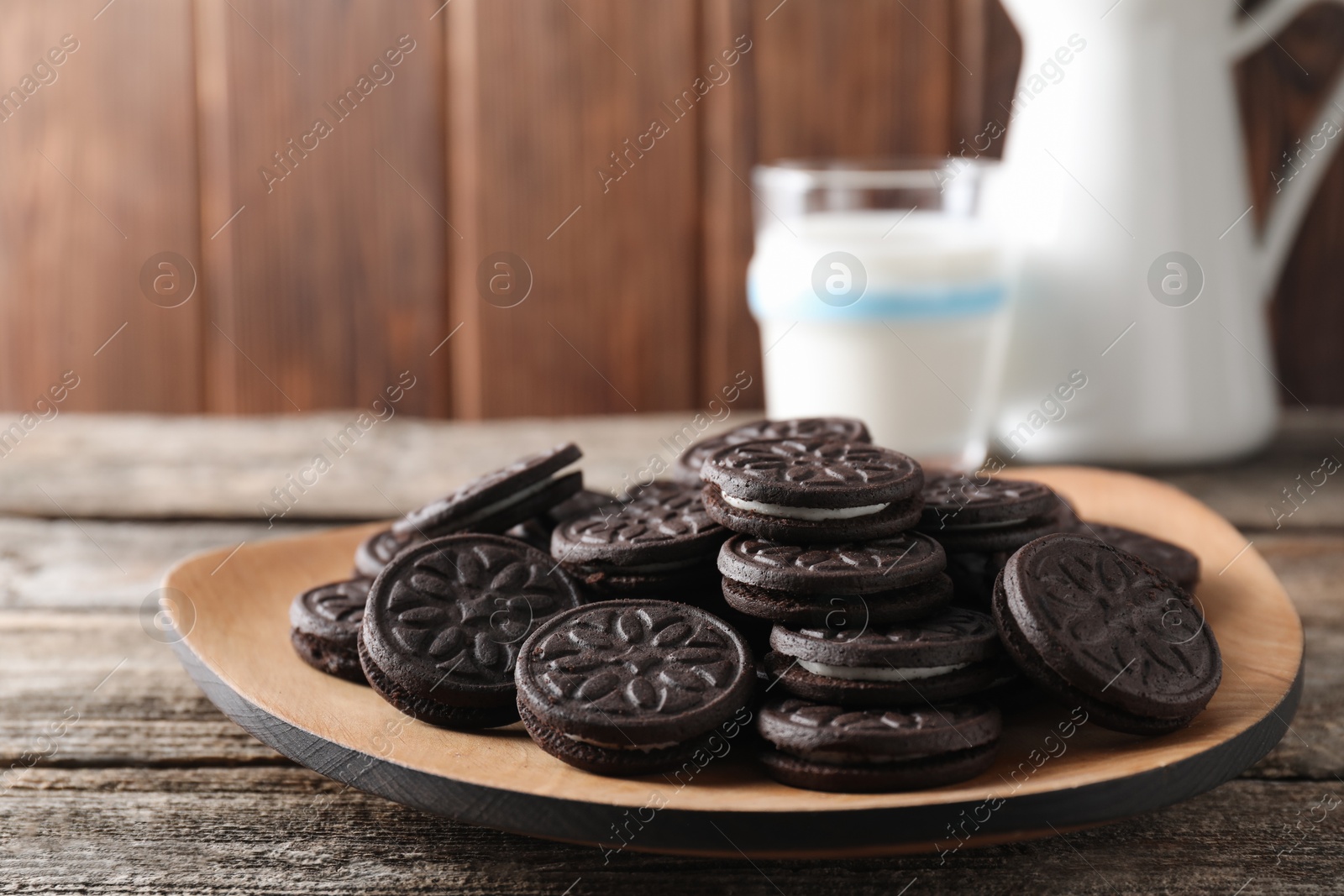 Photo of Many tasty sandwich cookies on wooden table