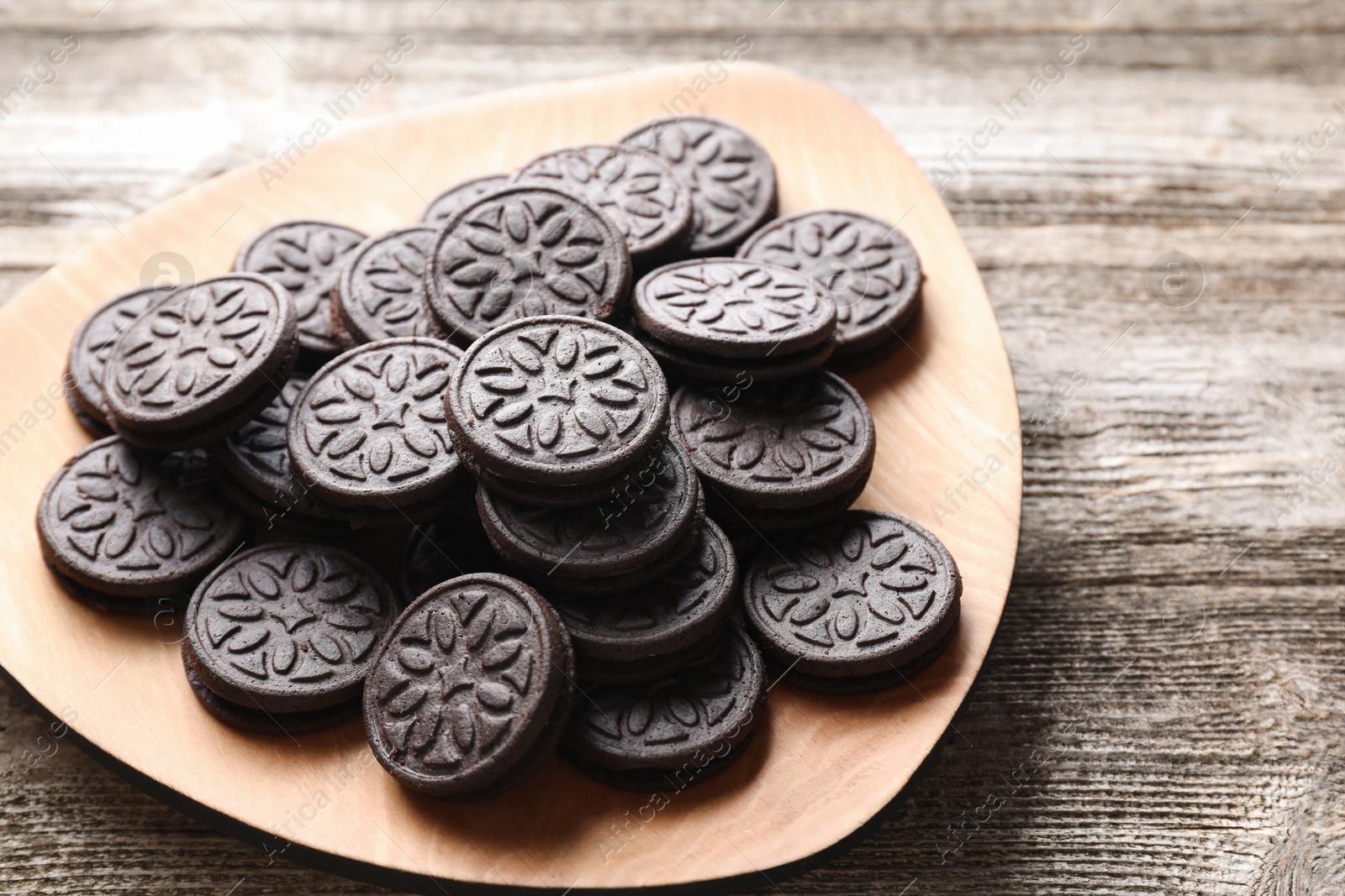 Photo of Many tasty sandwich cookies on wooden table