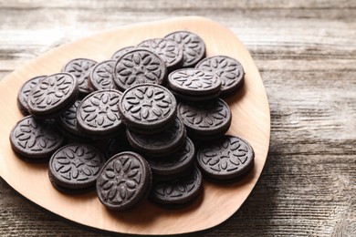 Many tasty sandwich cookies on wooden table