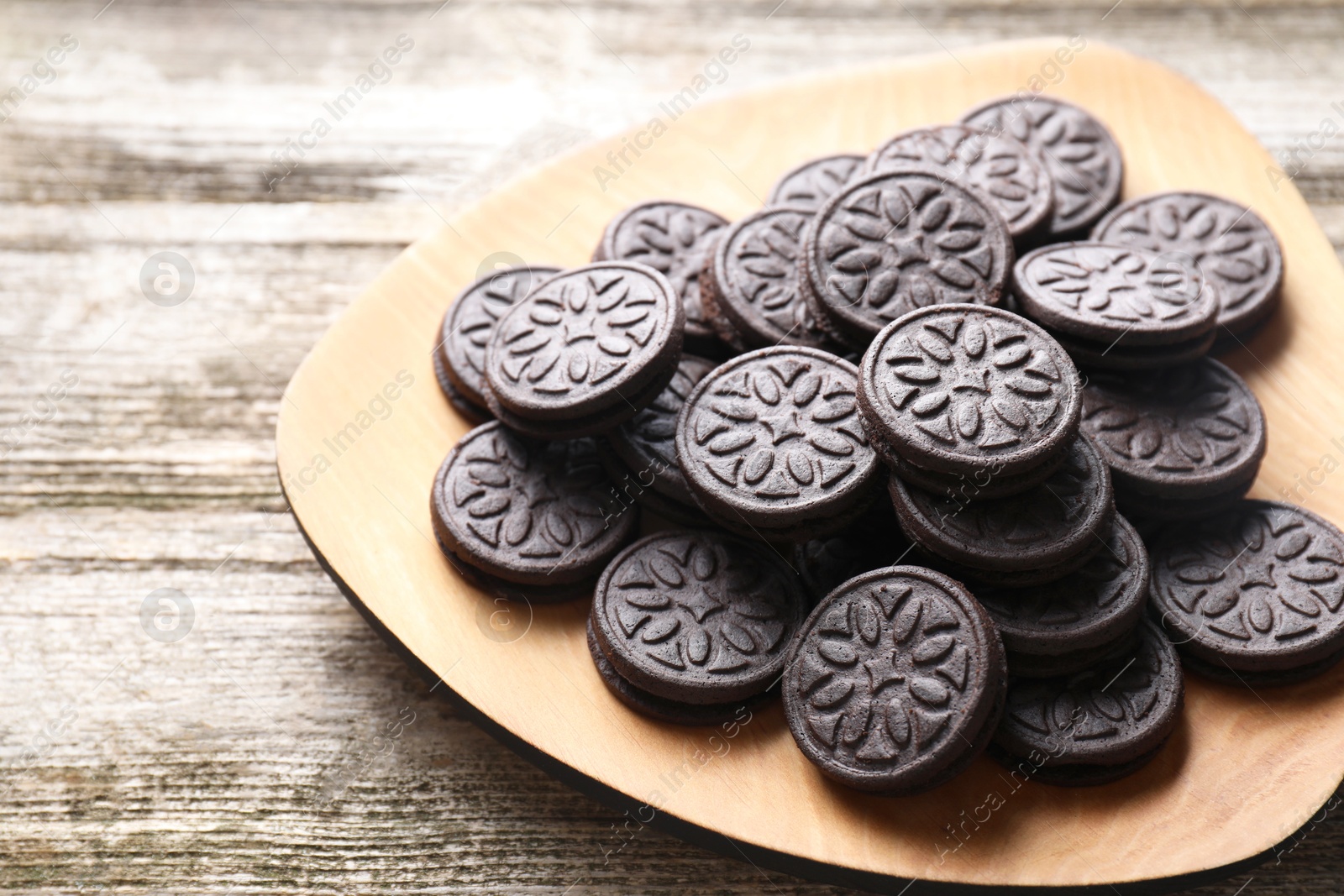 Photo of Many tasty sandwich cookies on wooden table