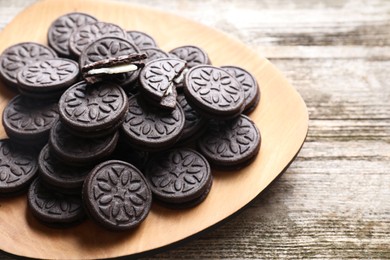 Many tasty sandwich cookies on wooden table