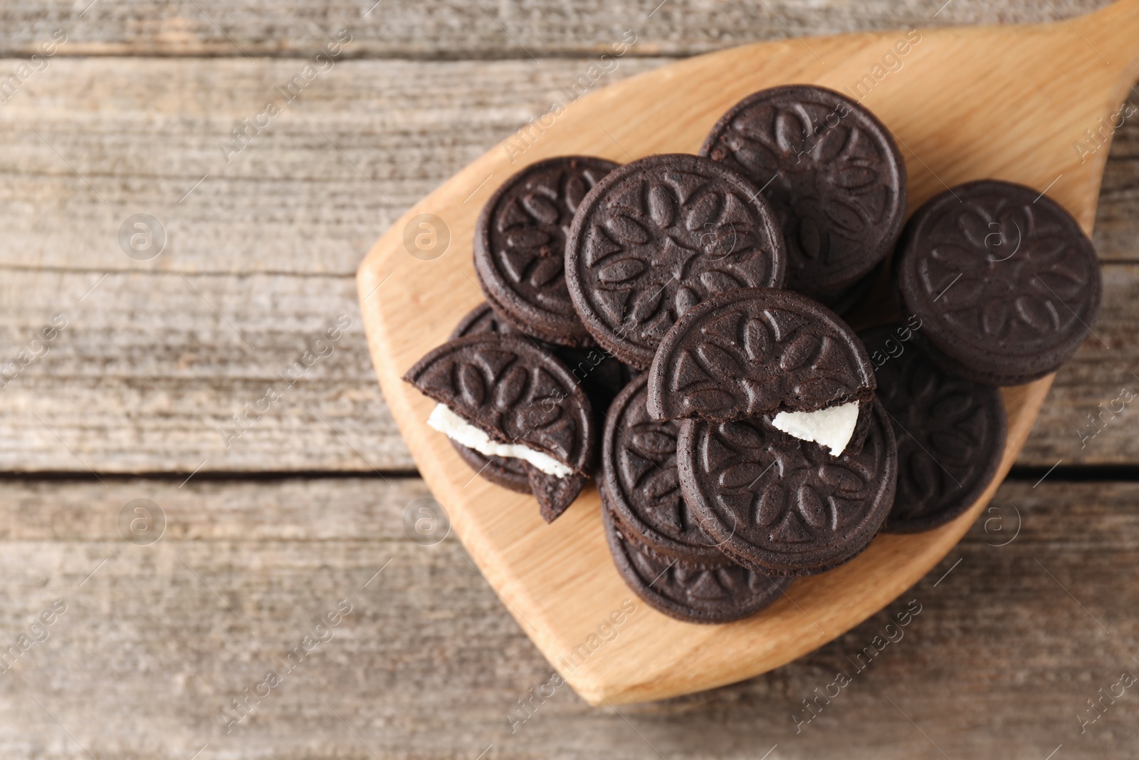 Photo of Many tasty sandwich cookies on wooden table, top view. Space for text