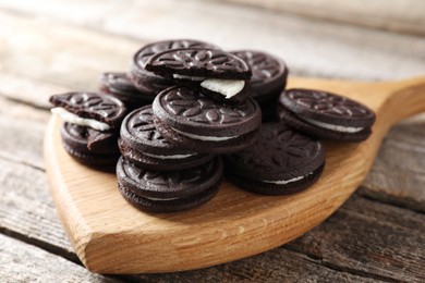 Photo of Many tasty sandwich cookies on wooden table