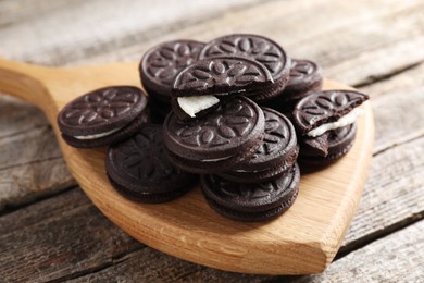 Photo of Many tasty sandwich cookies on wooden table