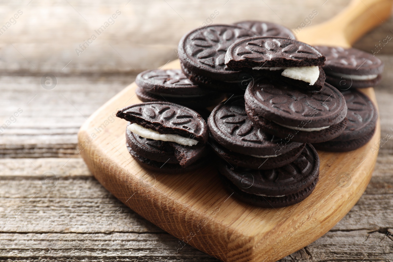 Photo of Many tasty sandwich cookies on wooden table