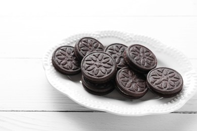 Photo of Many tasty sandwich cookies on white wooden table