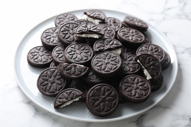 Photo of Tasty sandwich cookies on white marble table