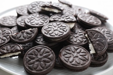 Photo of Tasty sandwich cookies on plate, closeup view