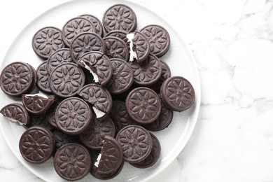 Photo of Tasty sandwich cookies on white marble table, top view. Space for text