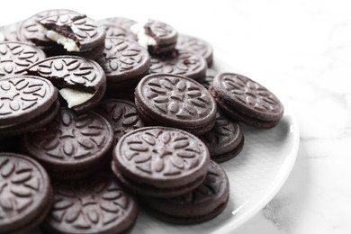 Tasty sandwich cookies on white marble table, closeup