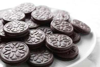 Photo of Tasty sandwich cookies on white marble table, closeup