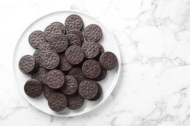 Photo of Tasty sandwich cookies on white marble table, top view. Space for text