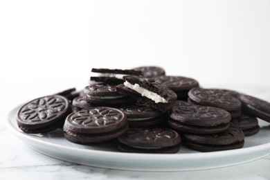 Tasty sandwich cookies on white marble table