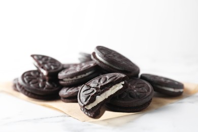 Photo of Tasty sandwich cookies on white marble table