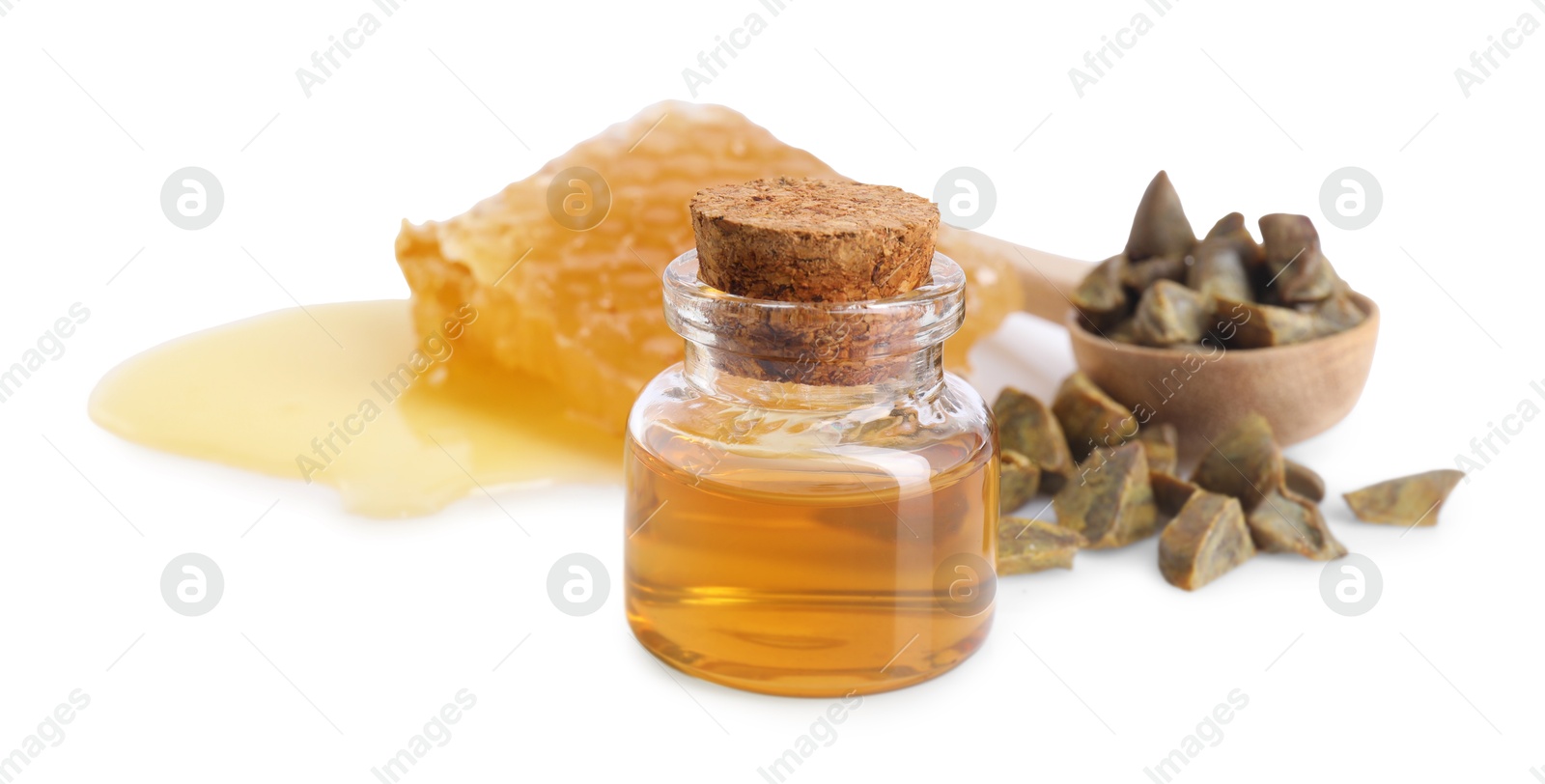 Photo of Natural honey tincture, propolis granules and sweet honeycomb isolated on white