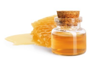 Photo of Natural honey tincture in bottle and sweet honeycomb isolated on white