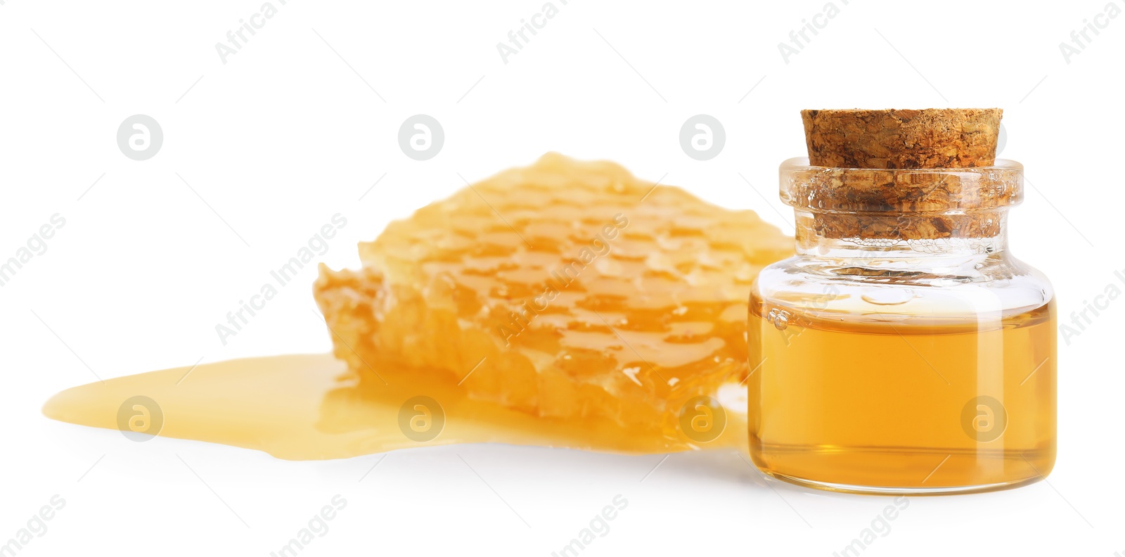 Photo of Natural honey tincture in bottle and sweet honeycomb isolated on white