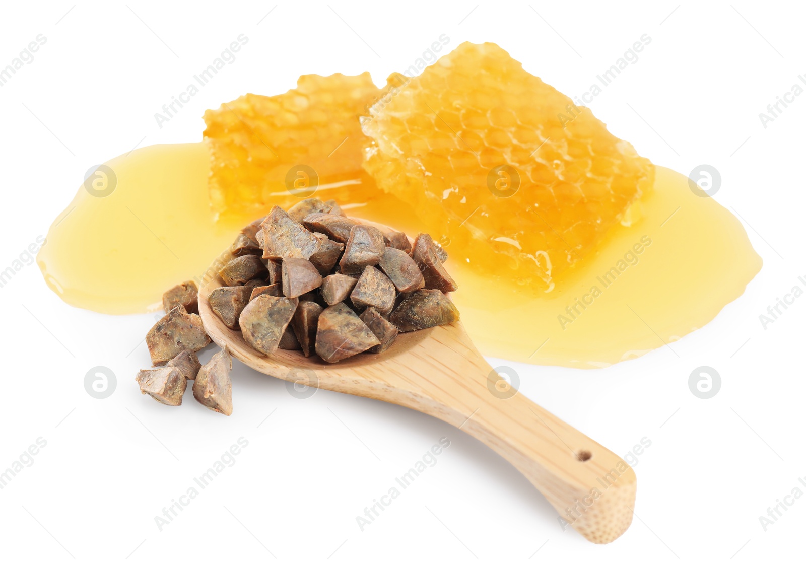 Photo of Sweet honeycombs and spoon with propolis granules isolated on white