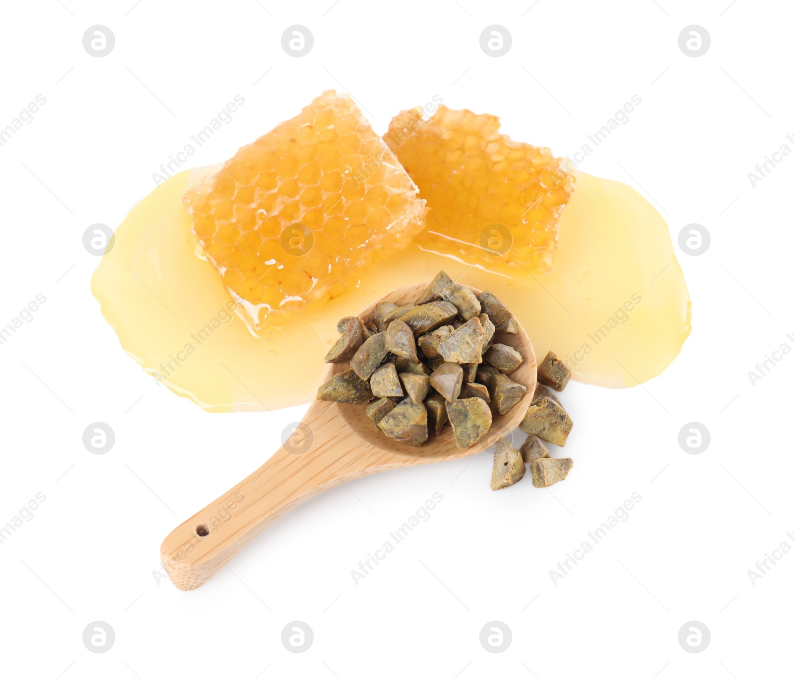 Photo of Sweet honeycombs and spoon with propolis granules isolated on white