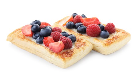 Photo of Tasty puff pastries with berries isolated on white