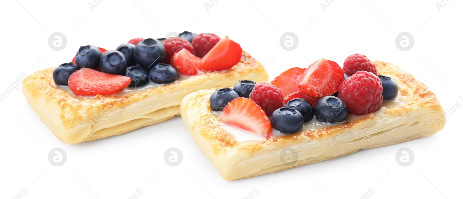 Photo of Tasty puff pastries with berries isolated on white