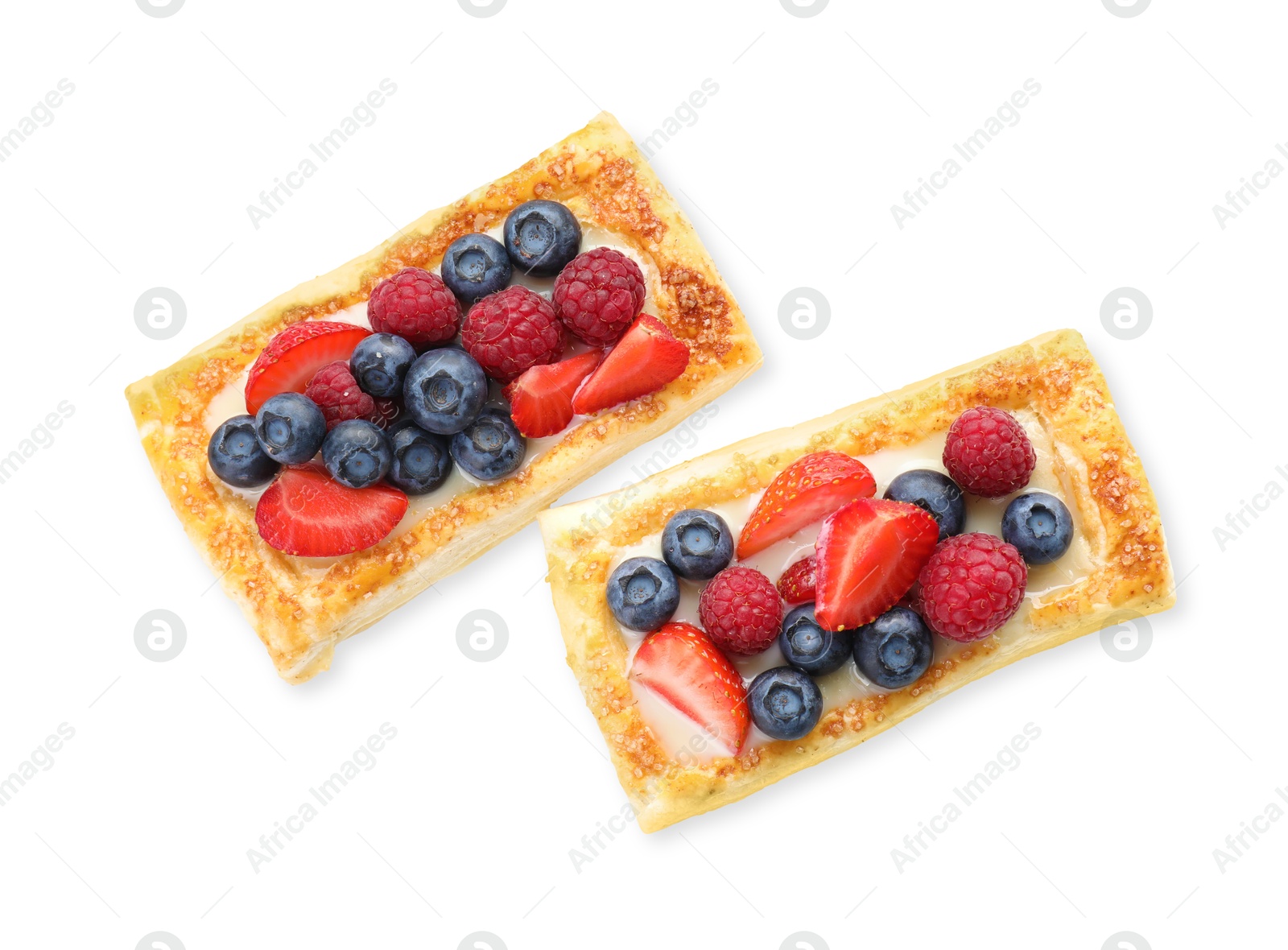 Photo of Tasty puff pastries with berries isolated on white, top view