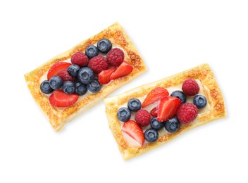 Photo of Tasty puff pastries with berries isolated on white, top view