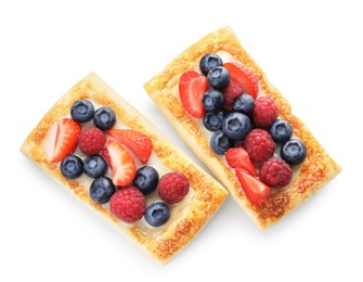 Tasty puff pastries with berries isolated on white, top view