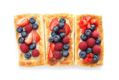 Photo of Tasty puff pastries with berries isolated on white, top view