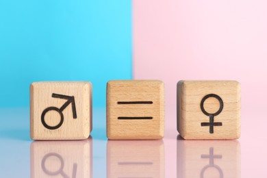 Photo of Gender equality concept. Cubes with male and female symbols on color background