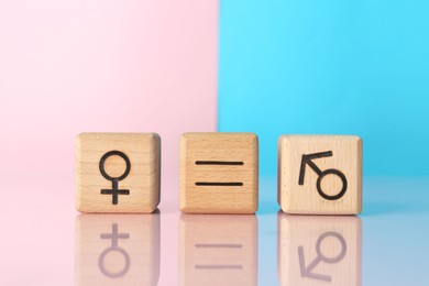 Photo of Gender equality concept. Cubes with male and female symbols on color background