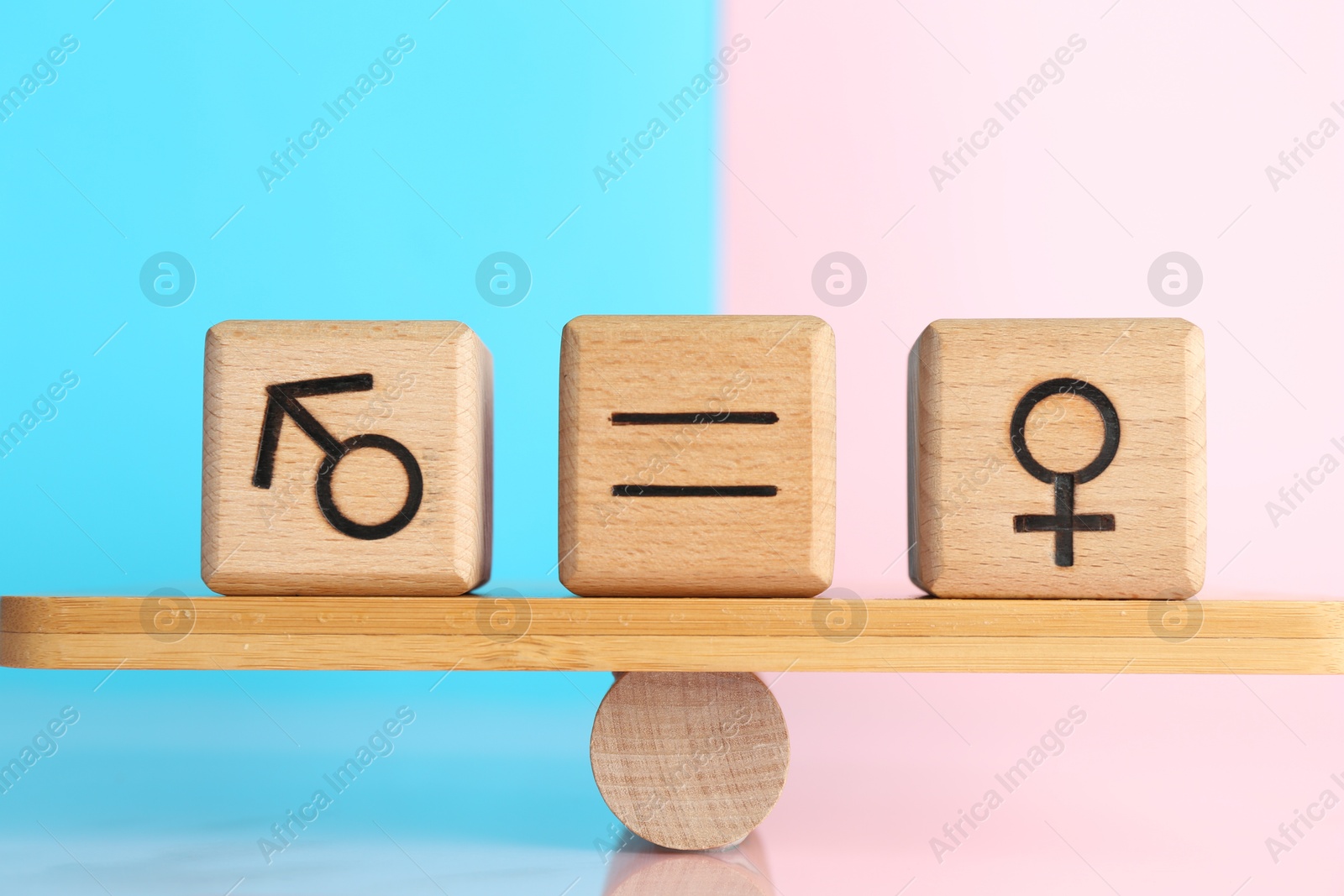 Photo of Gender equality concept. Cubes with male and female symbols on scales against color background