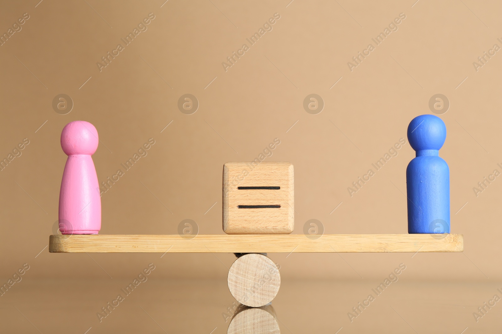 Photo of Gender equality concept. Cube with equals sign between male and female figures on scales against beige background