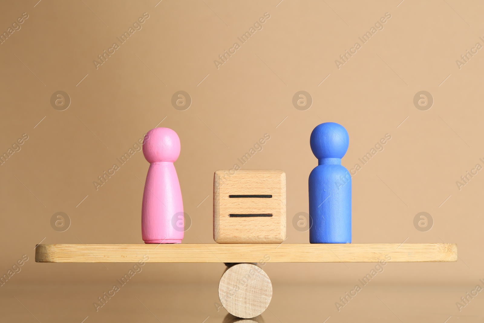 Photo of Gender equality concept. Cube with equals sign between male and female figures on scales against beige background