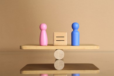 Photo of Gender equality concept. Cube with equals sign between male and female figures on scales against beige background