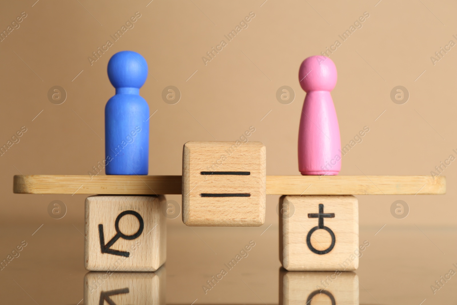 Photo of Gender equality concept. Cube with equals sign between male and female figures on scales against beige background