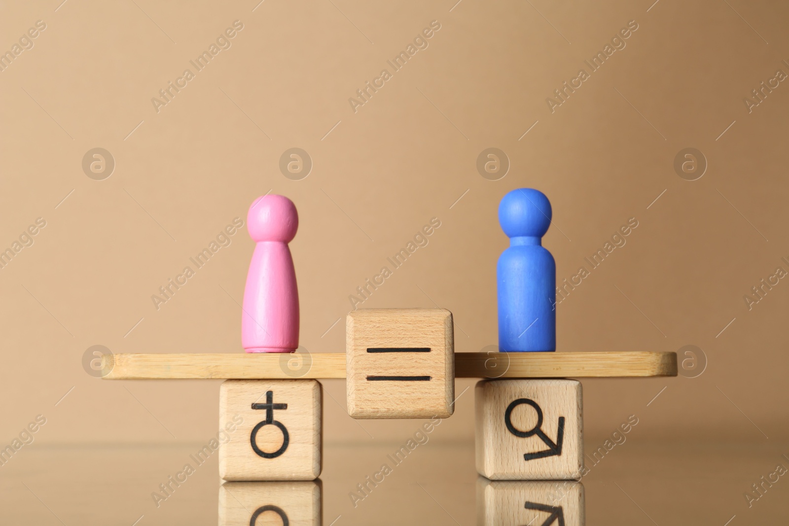 Photo of Gender equality concept. Cube with equals sign between male and female figures on scales against beige background