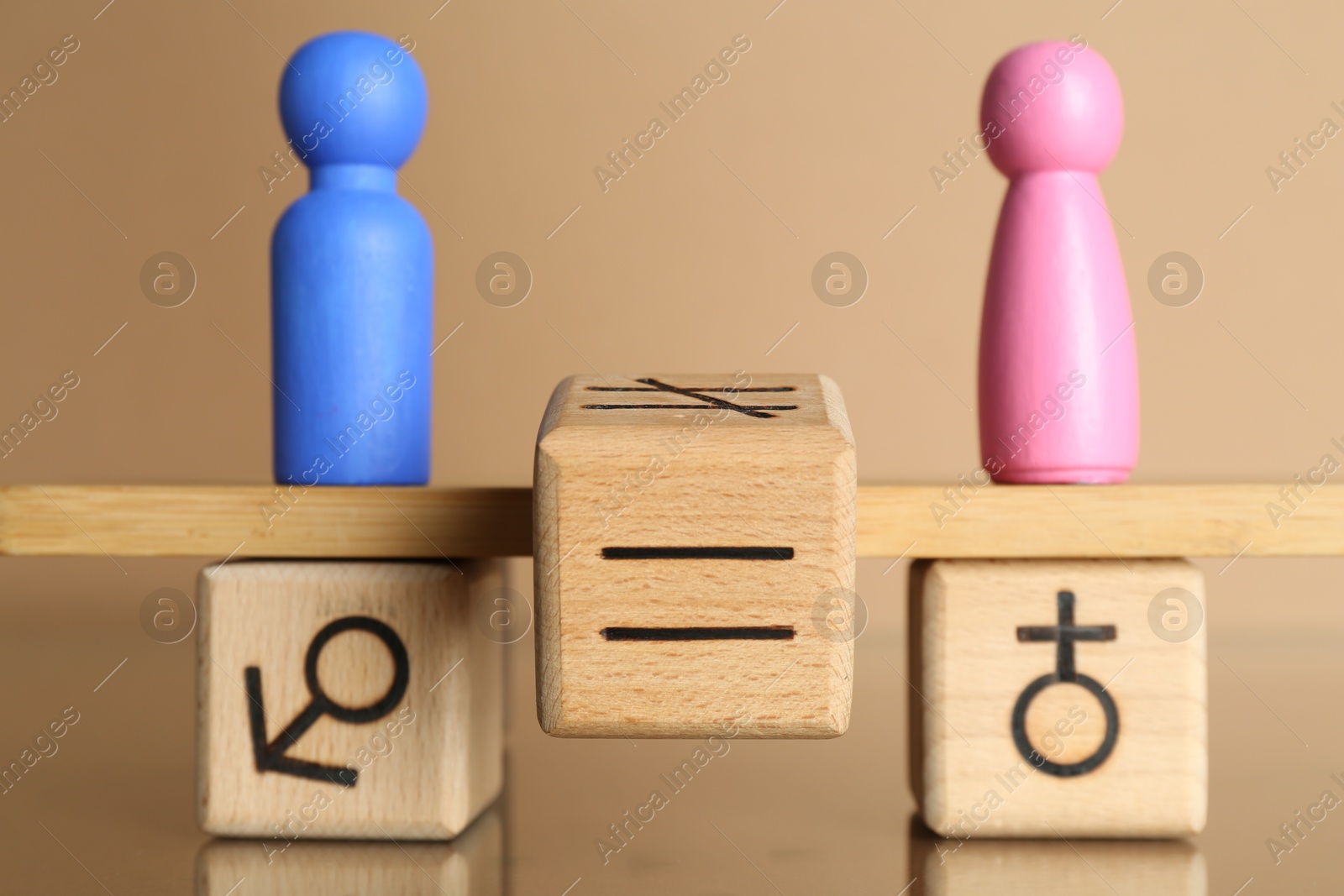 Photo of Gender equality concept. Cube with equals sign between male and female figures on scales against beige background