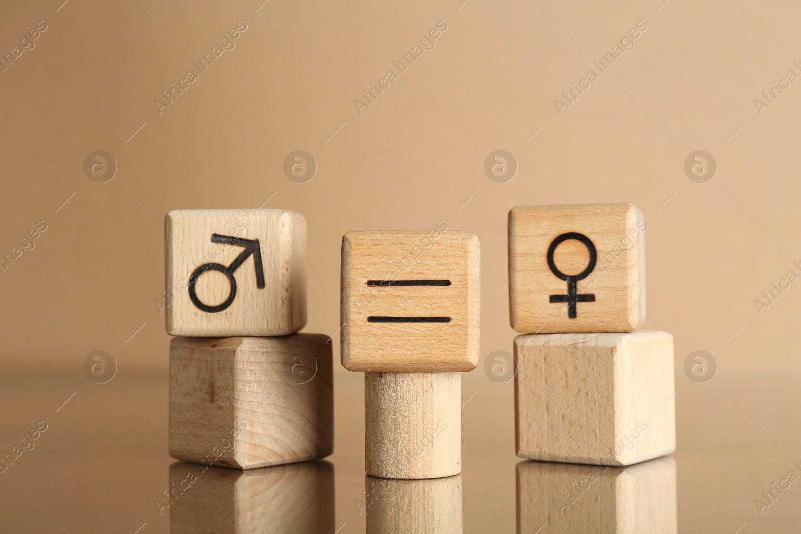 Photo of Gender equality concept. Cubes with male and female symbols on beige background