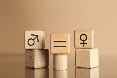 Gender equality concept. Cubes with male and female symbols on beige background