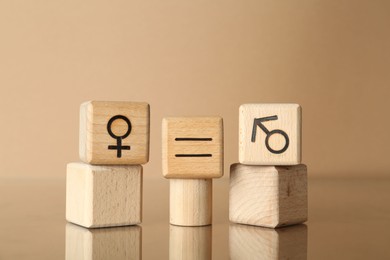 Gender equality concept. Cubes with male and female symbols on beige background