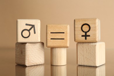 Photo of Gender equality concept. Cubes with male and female symbols on beige background