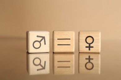 Gender equality concept. Cubes with male and female symbols on beige background