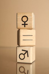 Photo of Gender equality concept. Cubes with male and female symbols on beige background