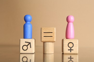 Photo of Gender equality concept. Male and female figures on beige background