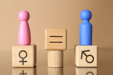 Photo of Gender equality concept. Male and female figures on beige background