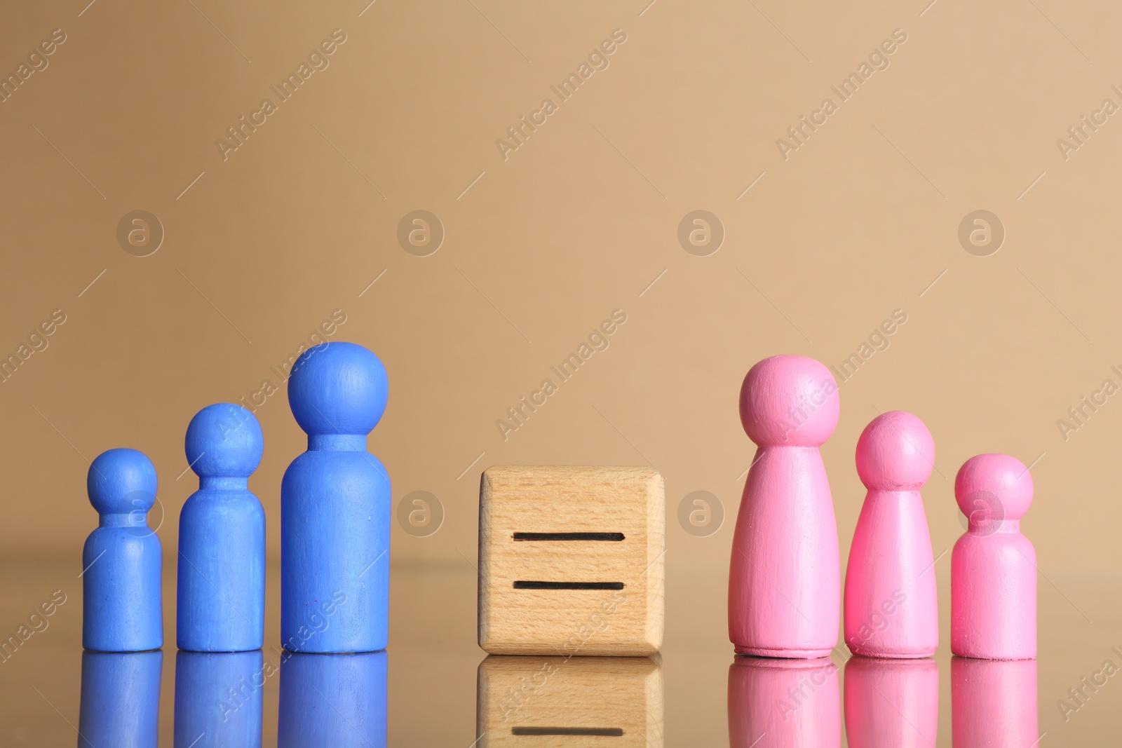 Photo of Gender equality concept. Male and female figures on beige background